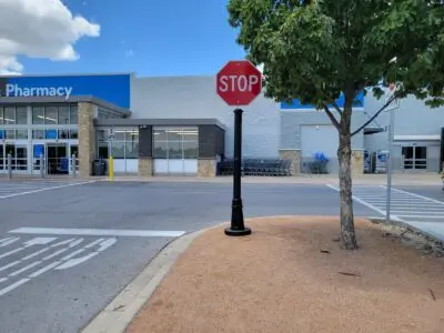 A decorative pole cover in front of a retail establishment.