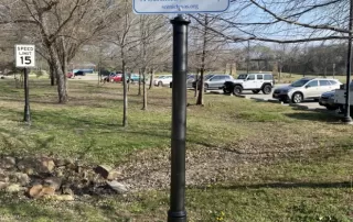 A decorative pole cover in a park setting