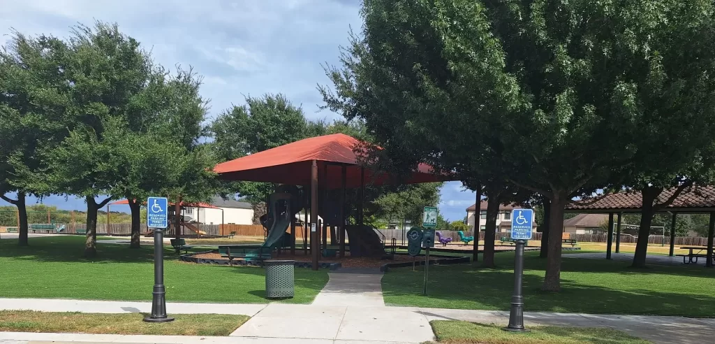 Two Pole Covers in front of an HOA playground